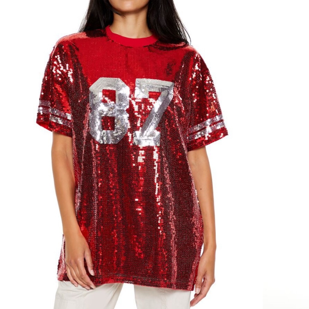 A knit tunic featuring allover sequin embellishments, front number "87" KC